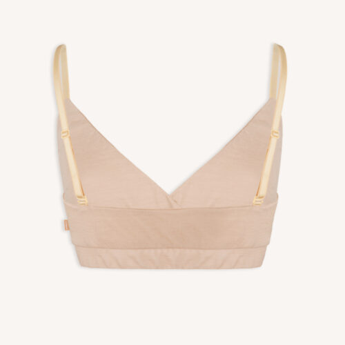 Stanik z wełny merino kopertowy cielisty beżowy to beżowy bralet z wełny merino z regulowanymi żółtymi ramiączkami i szerokim, podtrzymującym pasem, pokazany na gładkim białym tle.